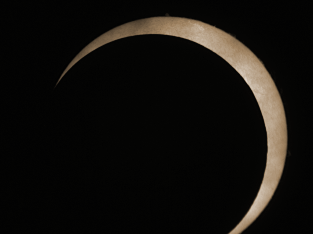 An image of the eclipse taken through the Coronado PST showing a little bit of the surface detail of the Sun.